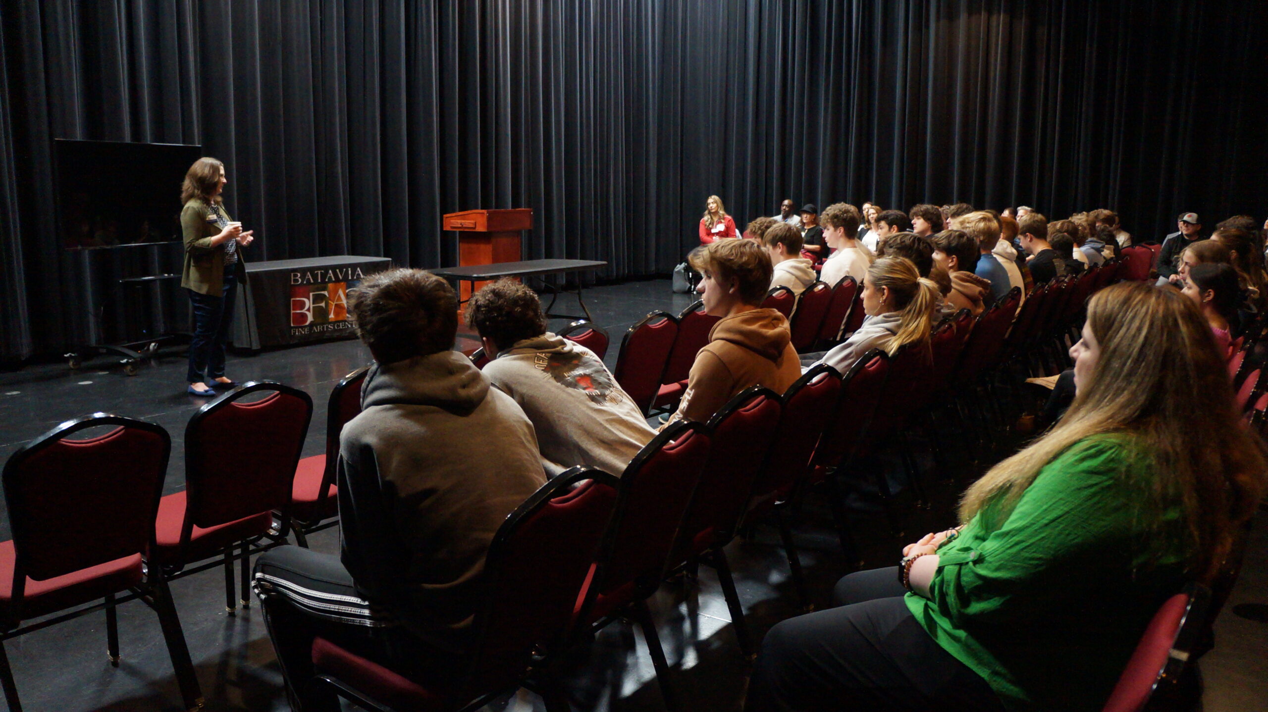 <p>Students in Black Box Listening to a Presentation by Margaret Perreault of the Batavia Chamber of Commerce</p>