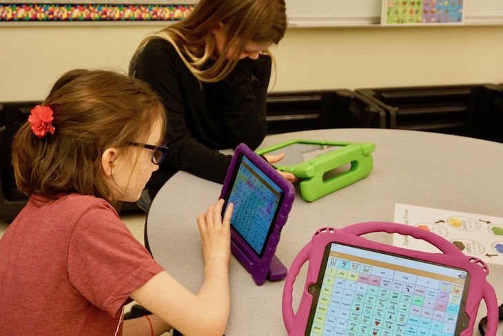 <p>GMS students learning how to use an electronic “talker.” </p>
